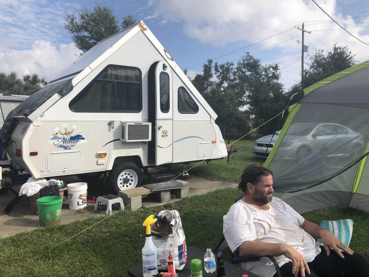 Tony Britt sits in front of the RV he and his wife have lived in for the last month as their new mobile home is equipped with utilities. The couple is rebuilding for the second time after Hurricane Laura ripped a hole in their roof.&#160;