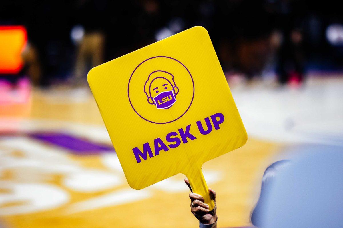 A Landmark security guard holds up a "mask up" COVID-19 sign Thursday, Feb. 25, 2021 during LSU women's basketball's 59-68 loss to Mississippi State in the Pete Maravich Assembly Center on N. Stadium Drive in Baton Rouge, La.