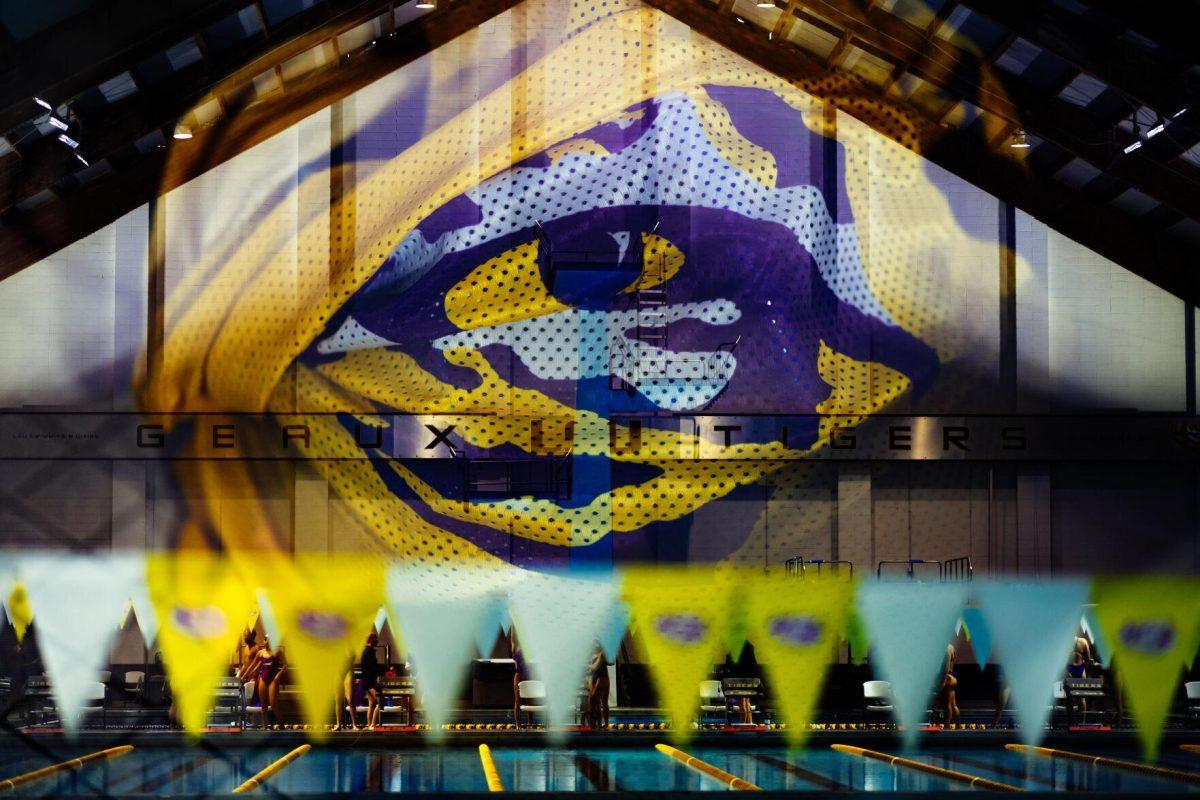 The LSU swim and dive "Geaux Tigers" sign hangs behind the diving platforms while the LSU tiger eye logo sits on an LSU gym bag Saturday, Oct. 9, 2021, during LSU's win over GCU at the LSU Natatorium in Baton Rouge, La.