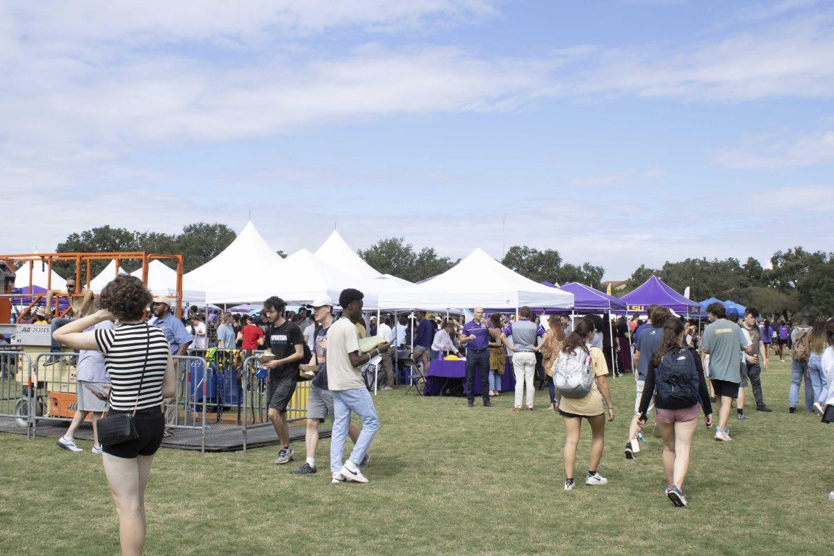 LSU students walk to different booths Friday, Oct. 15, 2021, during Fall Fest at the Parade Ground on LSU's campus.