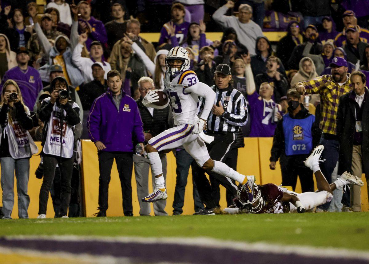 LSU wide receiver Trey Palmer (33) runs past Texas A&amp;M defensive back Jardin Gilbert (20) for a touchdown during the second quarter of an NCAA college football game in Baton Rouge, La., Saturday, Nov. 27, 2021. (AP Photo/Derick Hingle)