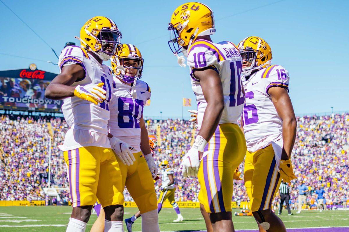 LSU football junior wide receiver Jaray Jenkins (10) celebrates his touchdown with freshman wide receiver Jack Bech (80), freshman wide receiver Brian Thomas Jr. (11) and junior wide receiver Devonta Lee (16) Saturday, Oct. 16, 2021, during LSU's 49-42 win against Florida at Tiger Stadium in Baton Rouge, La.