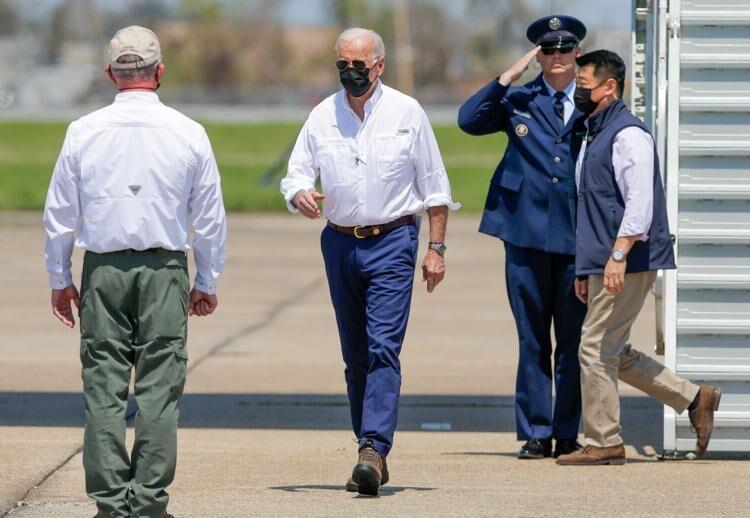 President Joe Biden greets Louisiana Gov. John Bel Edwards, left, after arriving at the Louis Armstrong New Orleans International Airport in Kenner on Friday, Sept. 3, 2021. Biden traveled to Louisiana to survey storm damage from Hurricane Ida and meet with officials.