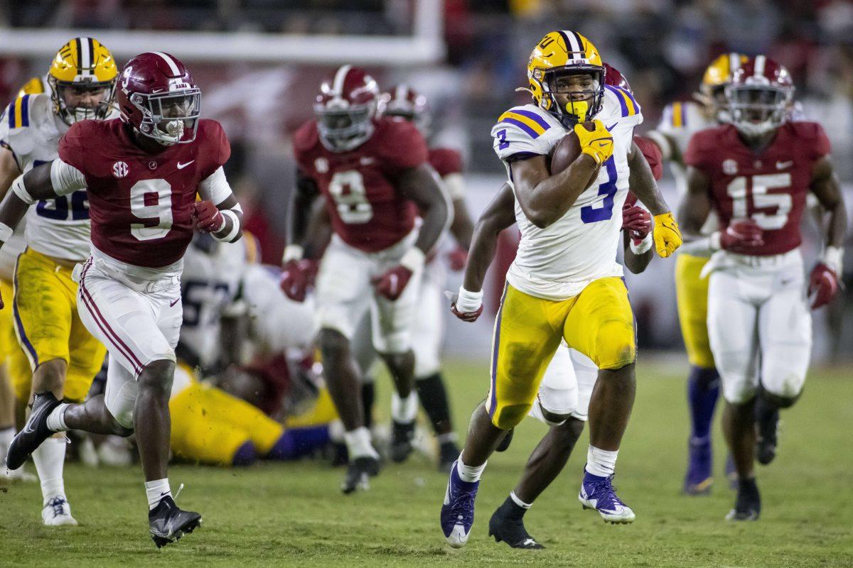 LSU running back Tyrion Davis-Price (3) breaks loose for a long run on a fourth-down play against Alabama during the second half of an NCAA college football game, Saturday, Nov. 6, 2021, in Tuscaloosa, Ala. (AP Photo/Vasha Hunt)