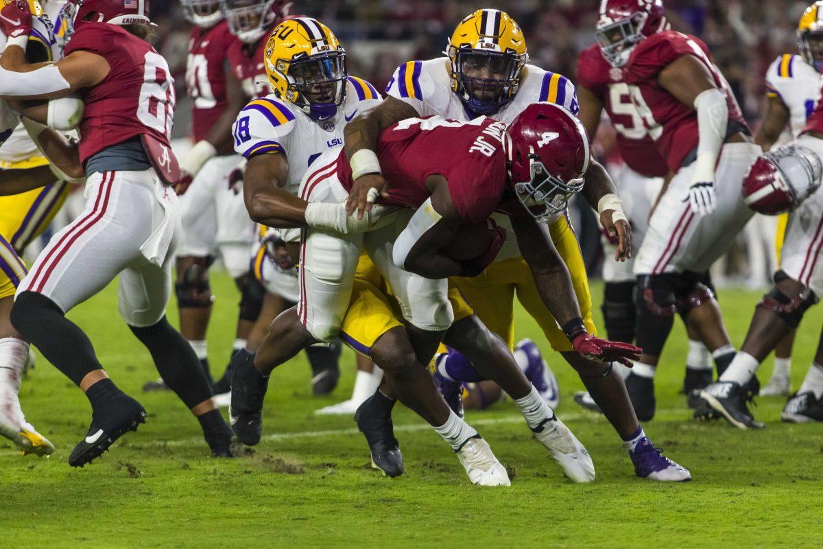 Alabama running back Brian Robinson Jr. (4) runs against LSU linebacker Damone Clark (18) and defensive lineman Neil Farrell Jr. (92) during the first half of an NCAA college football game, Saturday, Nov. 6, 2021, in Tuscaloosa, Ala. (AP Photo/Vasha Hunt)