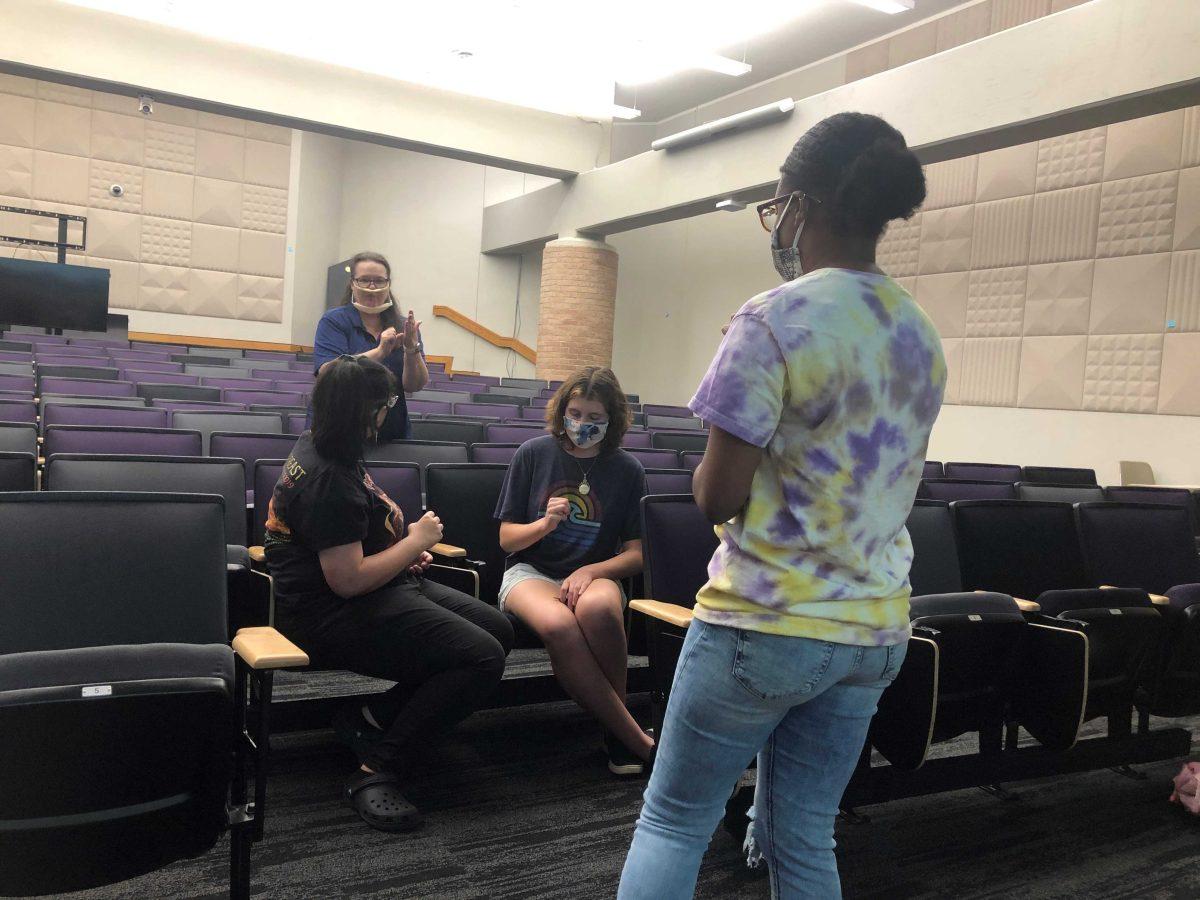 Deaf student and Hands That Hear officer, Rebekah Dupart, teaches an ASL lesson to club members at a meeting in 2021.&#160;