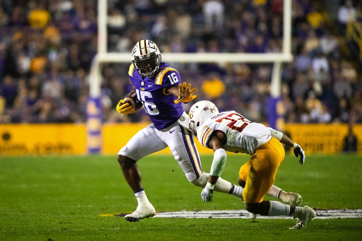 LSU football junior wide receiver Devonta Lee (16) prepares to stiff-arm ULM football senior cornerback Adam Sparks (22) Saturday, Nov. 20, 2021, during LSU’s 27-14 win against ULM in Tiger Stadium on North Stadium Drive in Baton Rouge, La.