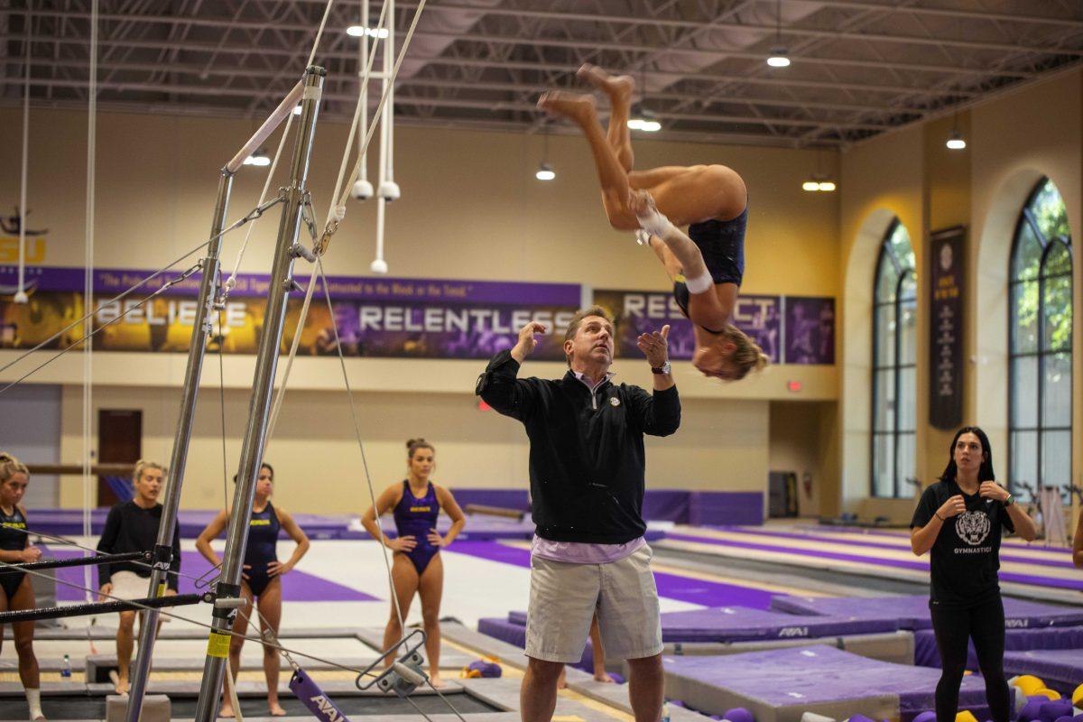 LSU gymnastics head coach Jay Clark spots graduate student vault, bars and beam Sami Durante Tuesday, Oct. 26, 2021, in the LSU Gymnastics Training Facility in Baton Rouge, La.