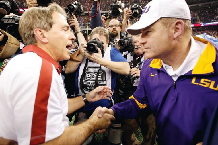 Alabama head coach Nick Saban and LSU head coach Les Miles greet each other after the BCS National Championship game in New Orleans in January. Saban seems pleased that a four-team playoff won'&#128;&#153;t be limited to conference champions. (AP photo)