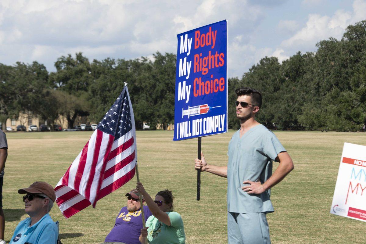 A Turning Point supporter holds a sign in protest of vaccine mandates Friday, Oct. 22, 2021 during the LSU chapter Turning Point Freedom Rally on the Parade Ground at LSU&#8217;s campus.