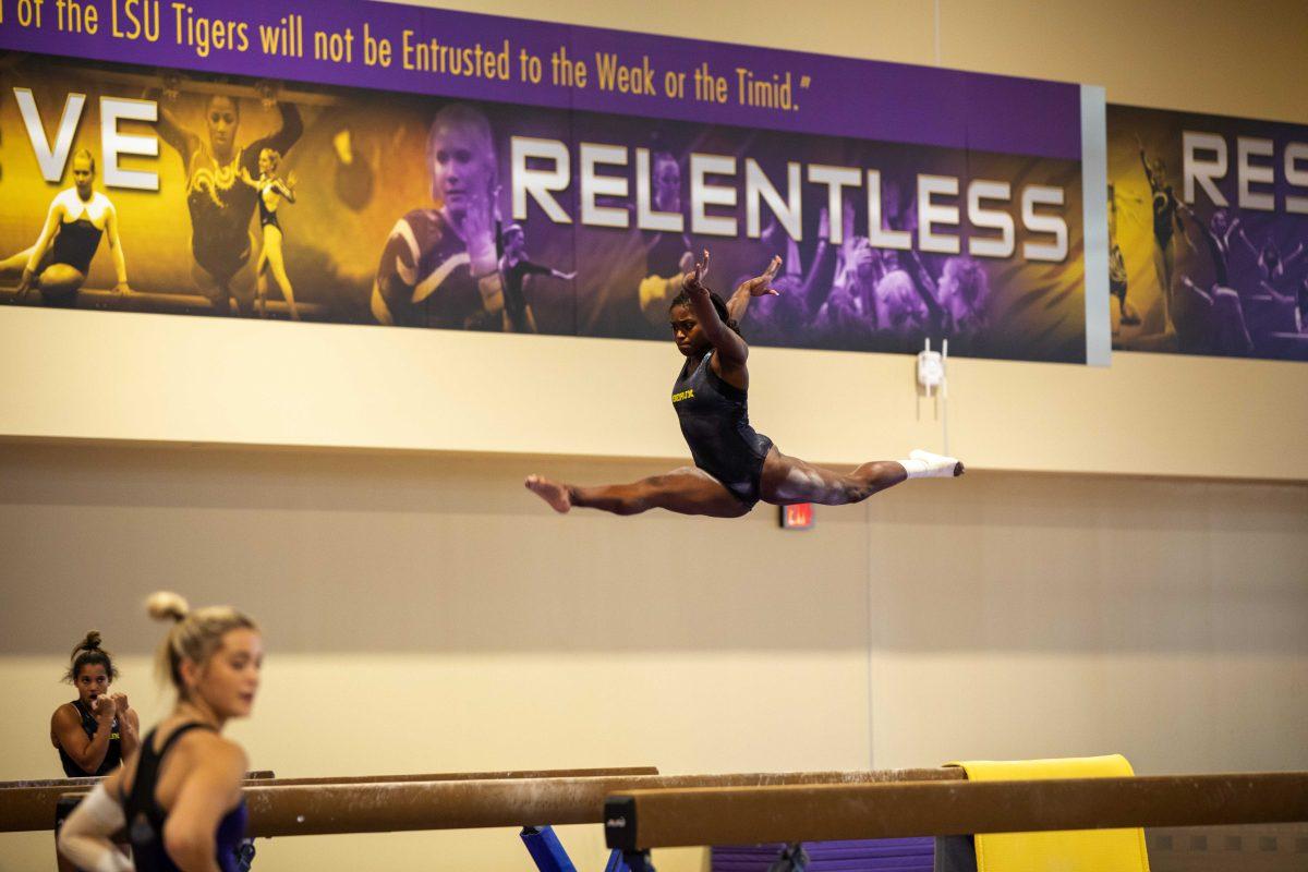 LSU gymnastics junior all-around Kiya Johnson does a split Tuesday, Oct. 26, 2021, above the balance beam in the LSU Gymnastics Training Facility in Baton Rouge, La.