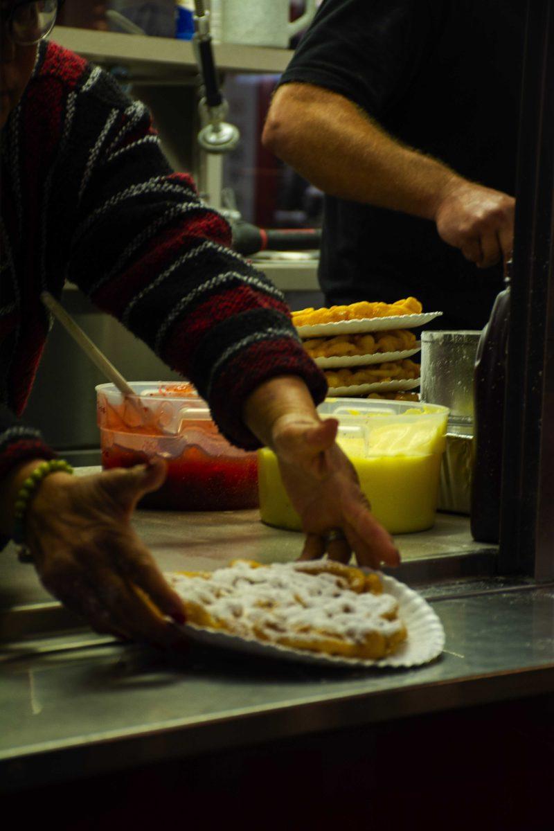 A funnel cake being served to a customer Friday, Nov. 5, 2021, at the Greater Baton Rouge State Fair on 16072 Airline Highway in Baton Rouge, La.