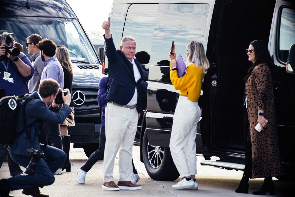 Newly hired LSU football head coach Brian Kelly throws up a thumbs up to LSU fans Tuesday, Nov. 30, 2021, before he takes the van back to LSU at the BTR Jet Center located in the Baton Rouge Metropolitan Airport on 4490 Blanche Noyes Avenue in Baton Rouge, La.