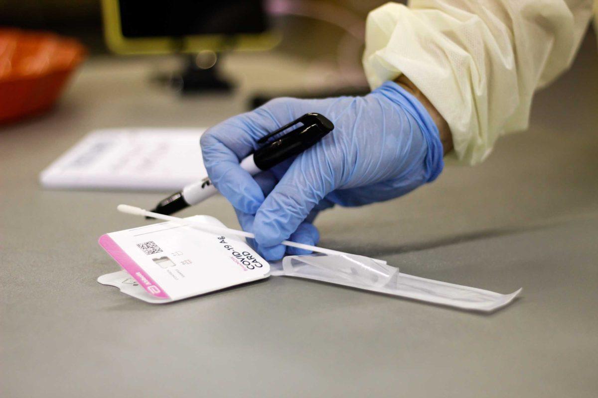 LSU COVID Testing assistant grabs testing swab for an LSU student on Friday, September 10, 2021.