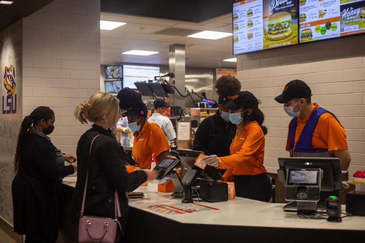 Cashiers take customers&#8217; orders Tuesday, Jan. 18, 2022, at Whataburger on 5851 Creek Centre Dr. in Baton Rouge, La.