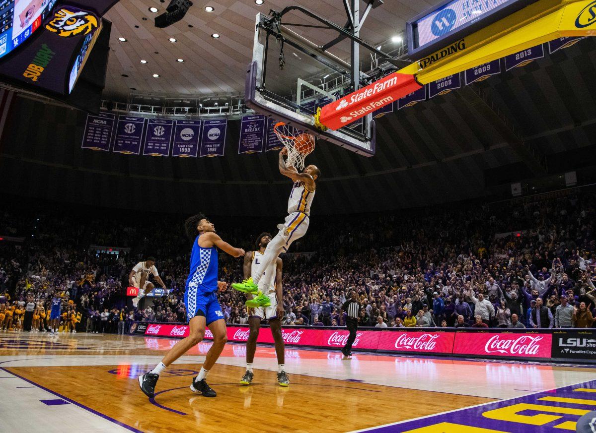 LSU men&#8217;s basketball senior guard Xavier Pinson (1) swings from the rim after dunking the ball Tuesday, Jan. 04, 2022, during LSU&#8217;s 56-50 win against Kentucky in the Pete Maravich Assembly Center on North Stadium Drive in Baton Rouge, La.