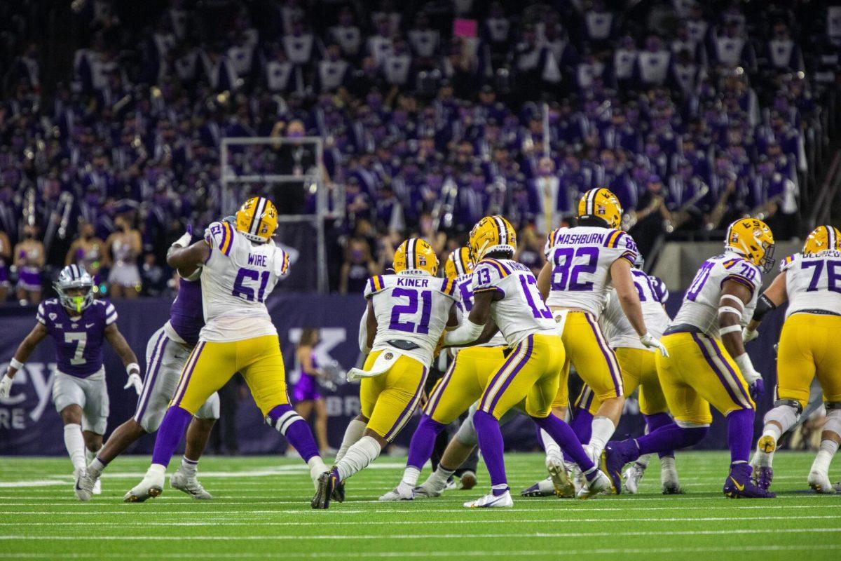 LSU football senior wide receiver Jontre Kirklin (13) hands the ball to freshman running back Corey Kiner (21) Tuesday, Jan. 4, 2022, during LSU&#8217;s 42-20 loss against Kansas State at NRG Stadium in Houston, TX.