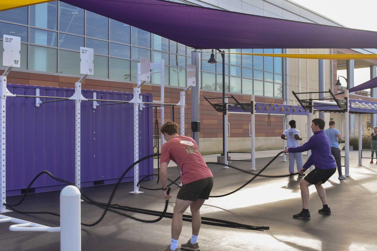 Two LSU students wave battle ropes Wednesday, Jan. 26, 2022, at the UREC Outdoor Fitness Space.