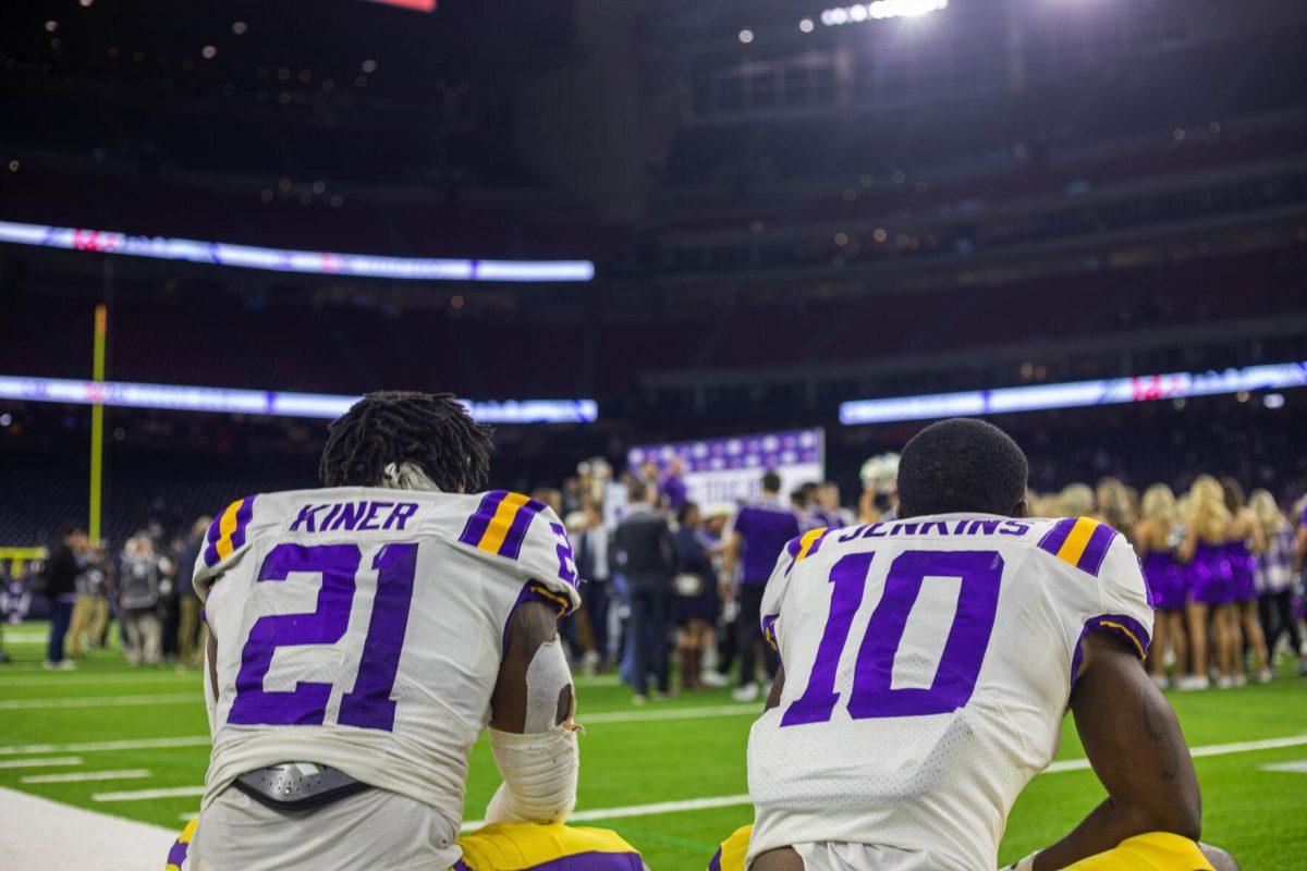 LSU football freshman running back Corey Kiner (21) and junior wide receiver Jaray Jenkins (10) look from a distance the trophy ceremony Tuesday, Jan. 4, 2022, during LSU&#8217;s 42-20 loss against Kansas State at NRG Stadium in Houston, TX.