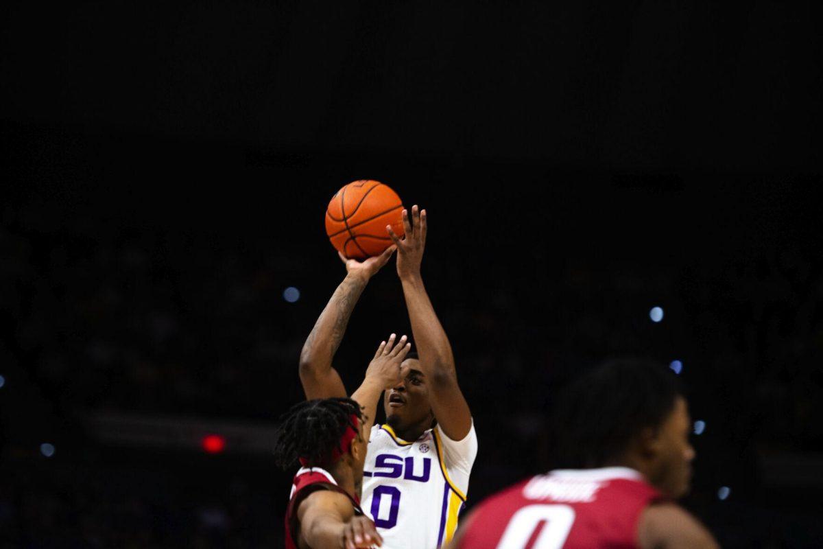 LSU men’s basketball freshman guard Brandon Murray (0) shoots a jump shot with a hand in his face Jan. 15, 2022, during LSU’s 65-58 loss against Arkansas in the Pete Maravich Assembly Center on North Stadium Drive in Baton Rouge, La.