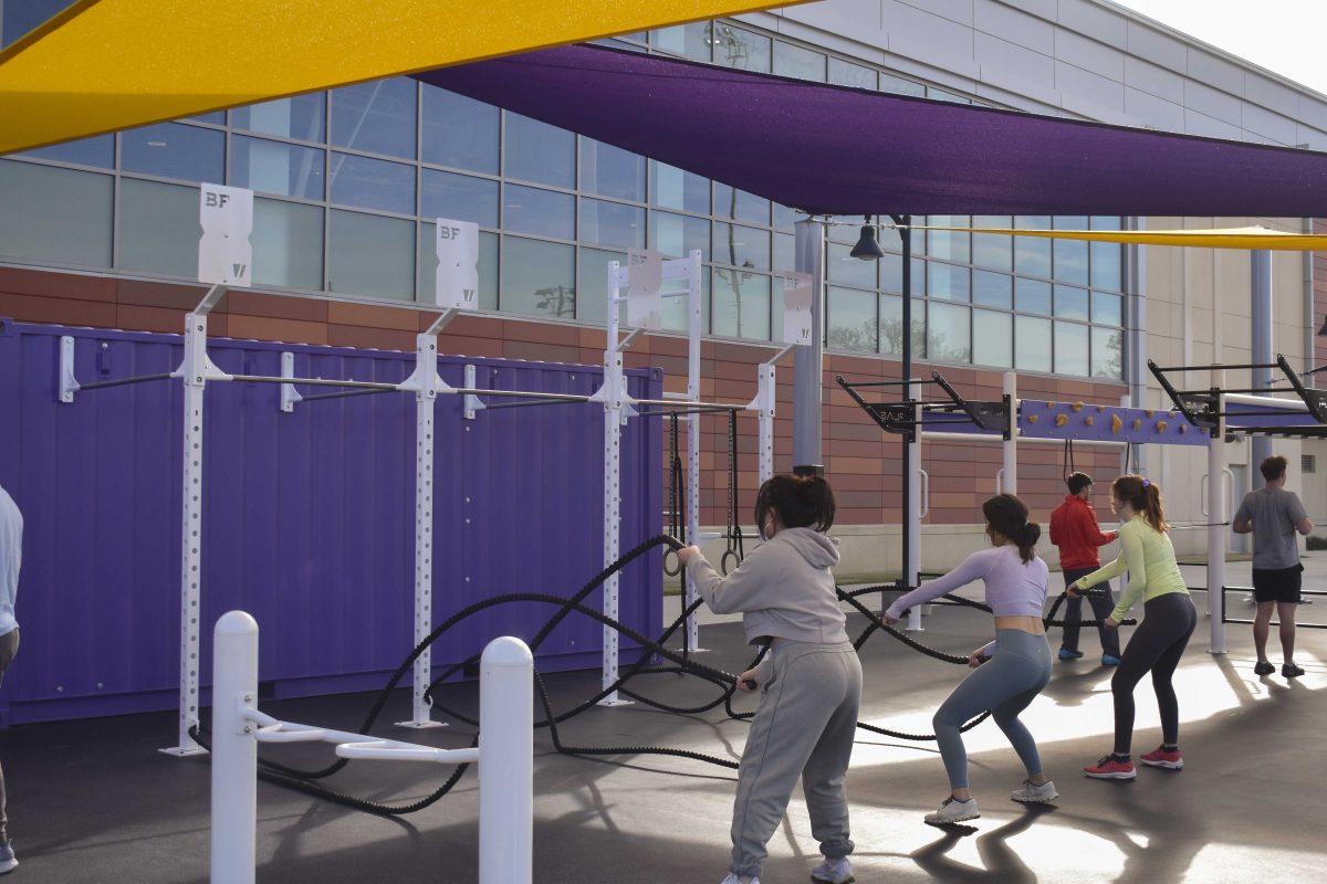 Three LSU students wave battle ropes Wednesday, Jan. 26, 2022, at the UREC Outdoor Fitness Space.