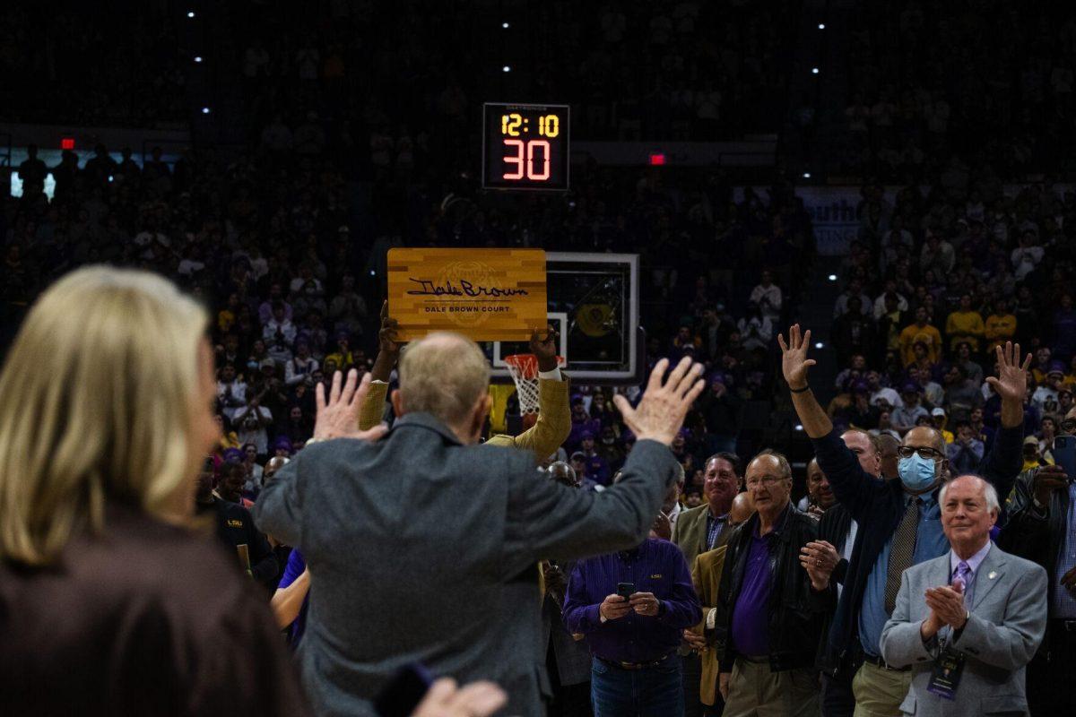 Longtime LSU basketball coach Dale Brown waves to his former players Tuesday, Jan. 04, 2022, during LSU&#8217;s 56-50 win against Kentucky in the Pete Maravich Assembly Center on North Stadium Drive in Baton Rouge, La.