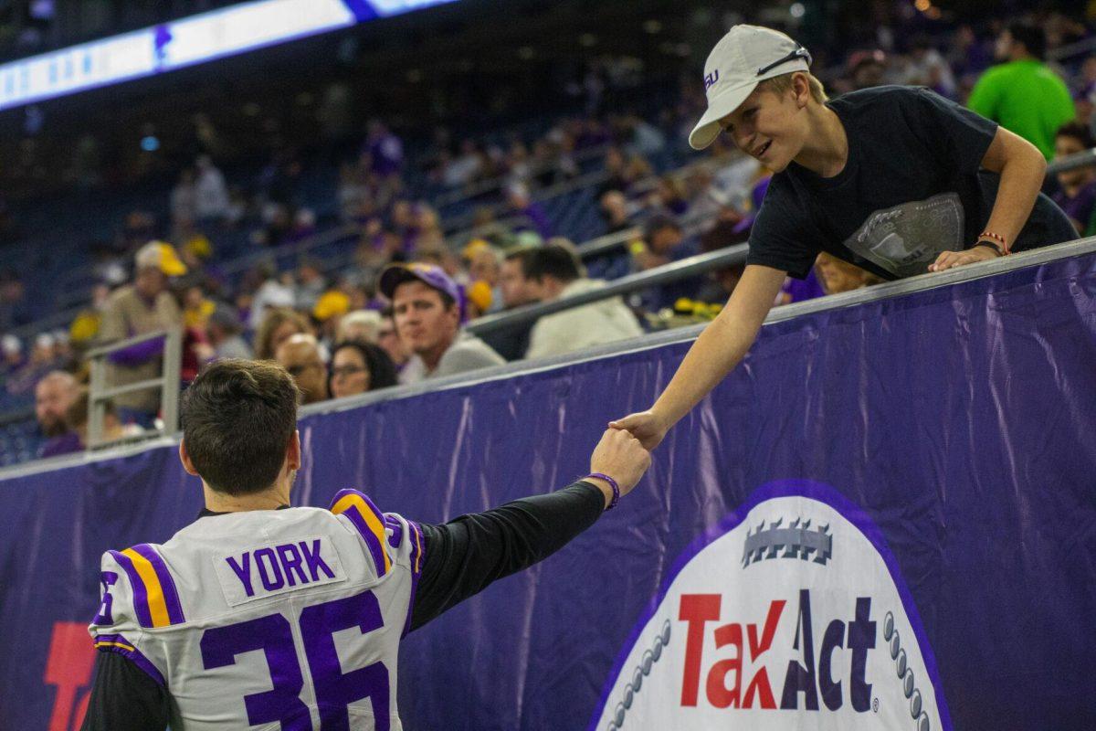 LSU football junior placekicker Cade York (36) greets a fan Tuesday, Jan. 4, 2022, during LSU&#8217;s 42-20 loss against Kansas State at NRG Stadium in Houston, TX.