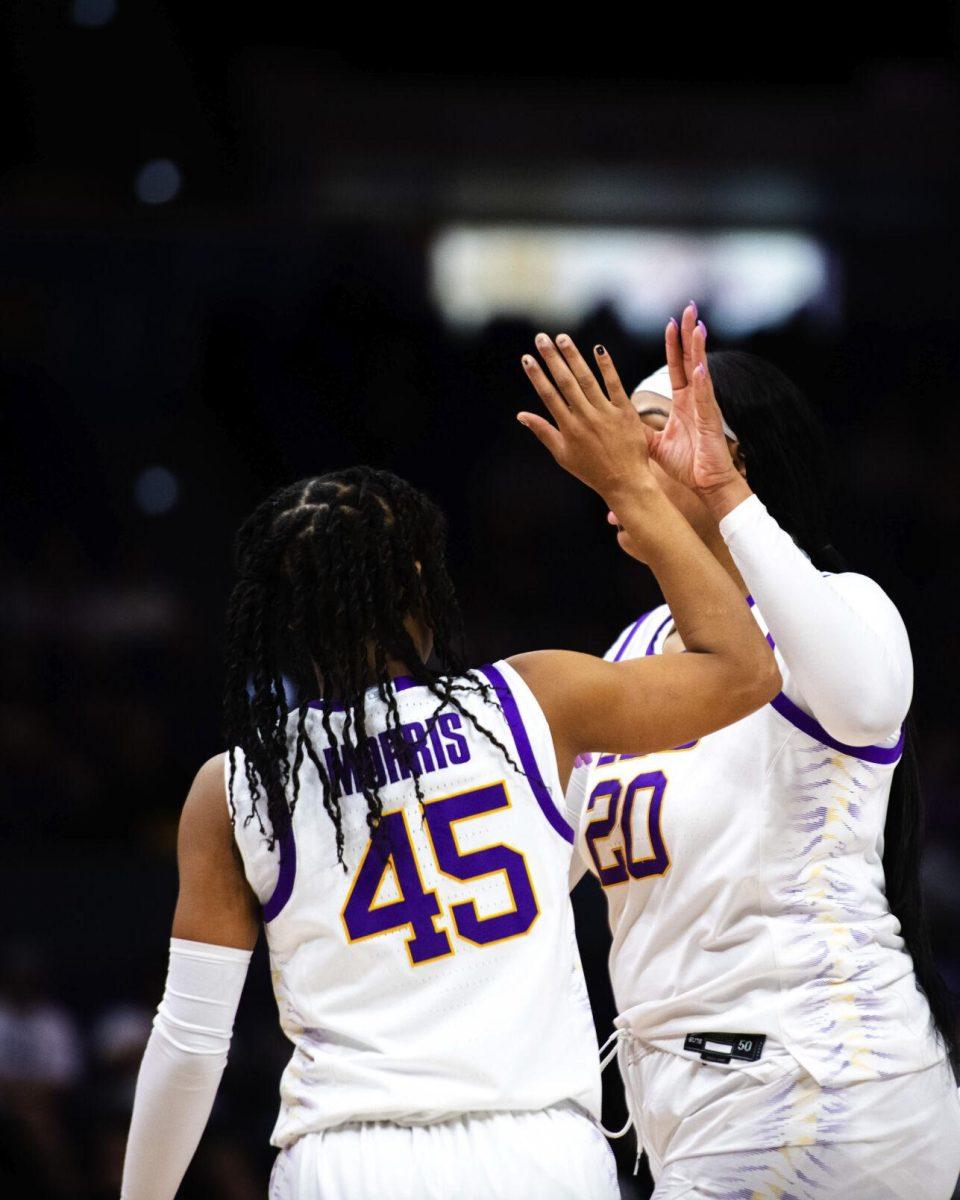 LSU women’s basketball senior guard Alexis Morris (45) and sophomore center Hannah Gusters (20) high five each other Thursday, Jan. 13, 2022, during LSU’s 87-85 overtime win against Missouri in the Pete Maravich Assembly Center on North Stadium Drive in Baton Rouge, La.