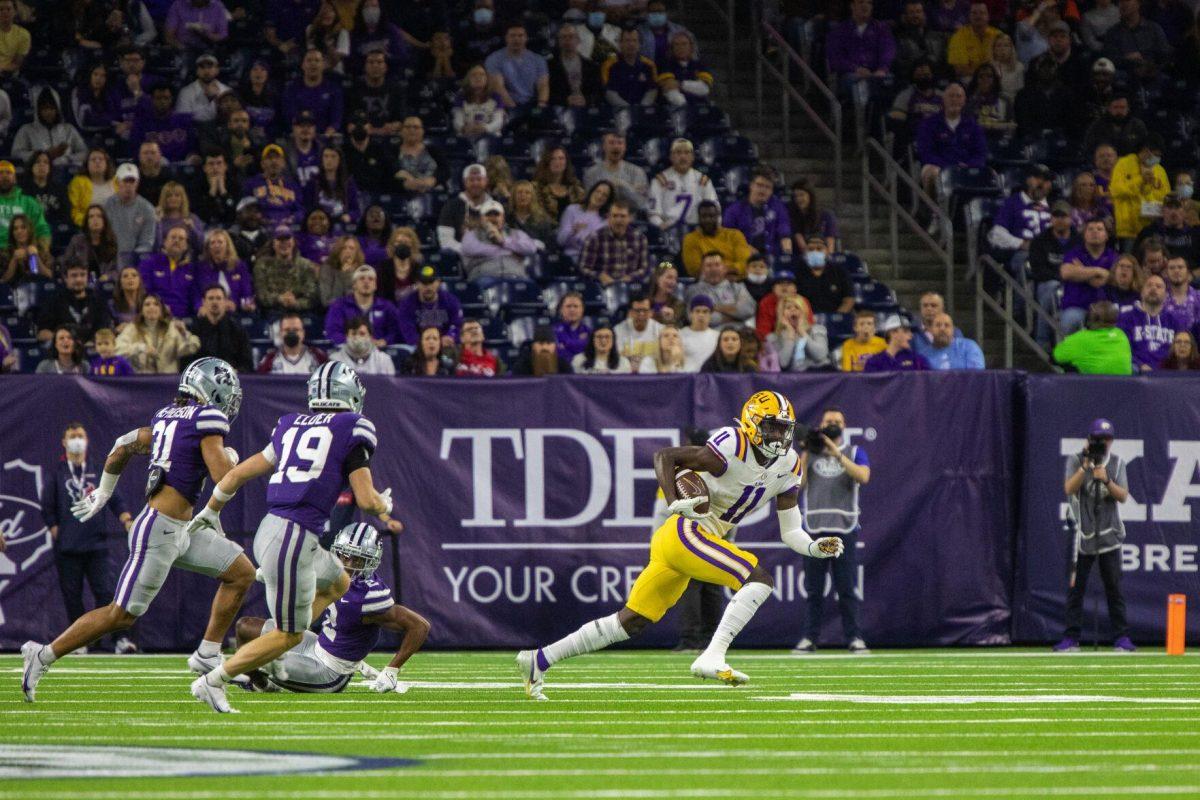 LSU football freshman wide receiver Brian Thomas Jr. (11) catches a pass and runs past defenders Tuesday, Jan. 4, 2022, during LSU&#8217;s 42-20 loss against Kansas State at NRG Stadium in Houston, TX.