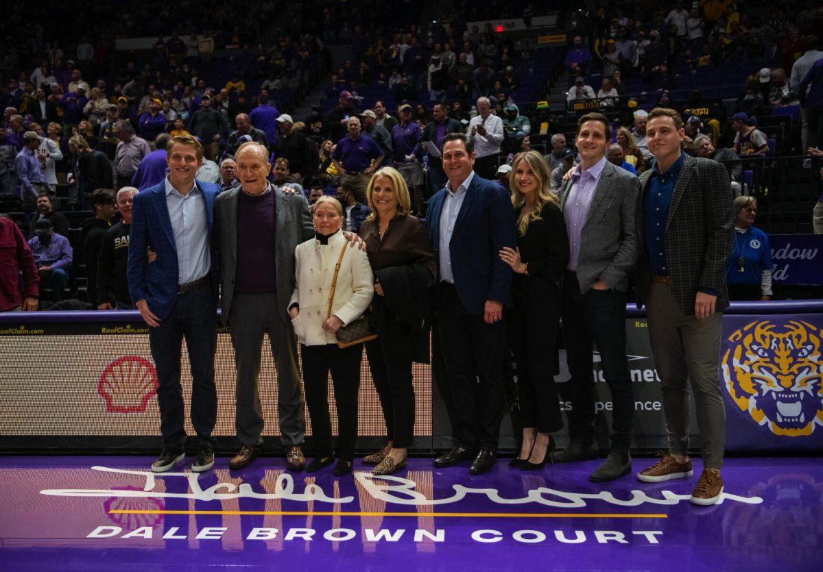 Longtime LSU basketball coach Dale Brown and his family pose by the new &#8220;Dale Brown Court&#8221; Tuesday, Jan. 04, 2022, before LSU&#8217;s 56-50 win against Kentucky in the Pete Maravich Assembly Center on North Stadium Drive in Baton Rouge, La.