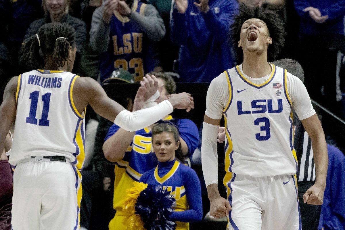 LSU forward Alex Fudge (3) reacts with guard Justice Williams (11) during the first half an NCAA college basketball game against Texas A&amp;M in Baton Rouge, La., Wednesday, Jan. 26, 2022. (AP Photo/Matthew Hinton)