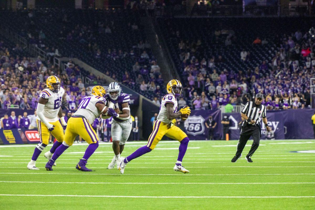 LSU football senior wide receiver Jontre Kirklin (13) scrambles and looks for a receiver in the endzone Tuesday, Jan. 4, 2022, during LSU&#8217;s 42-20 loss against Kansas State at NRG Stadium in Houston, TX.