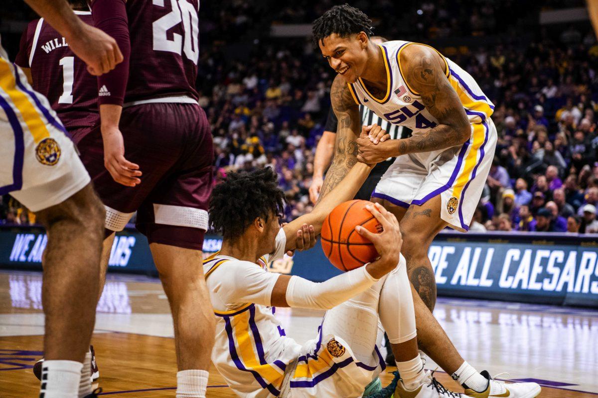 LSU men&#8217;s basketball junior forward Shareef O&#8217;Neal (24) helps up LSU men&#8217;s basketball freshman forward Alex Fudge (3) Wednesday, Jan. 26, 2022, during LSU&#8217;s 70-64 win against Texas A&amp;M in the Pete Maravich Assembly Center on North Stadium Drive in Baton Rouge, La.