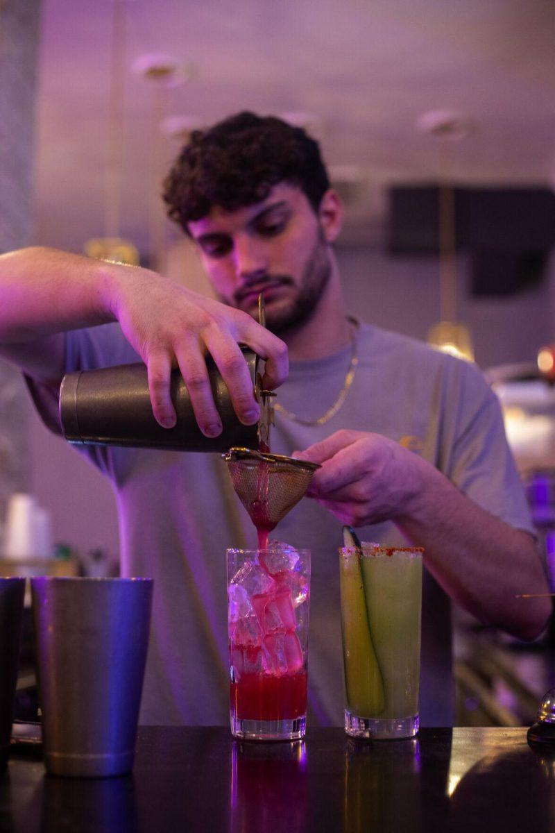 LSU alumni environmental management systems major, class of 2021, Patrick Winkeljohn pours a drink into a glass Tuesday, Jan. 18, 2022, at Rock Paper Taco on 166 W Chimes St. in Baton Rouge, La.