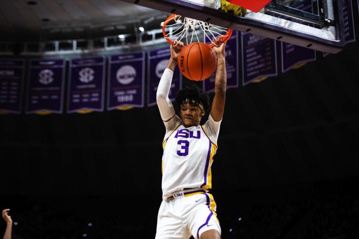 LSU men’s basketball freshman forward Alex Fudge (3) hangs on the rim after dunking the ball Saturday, Jan. 15, 2022, during LSU’s 65-58 loss against Arkansas in the Pete Maravich Assembly Center on North Stadium Drive in Baton Rouge, La.