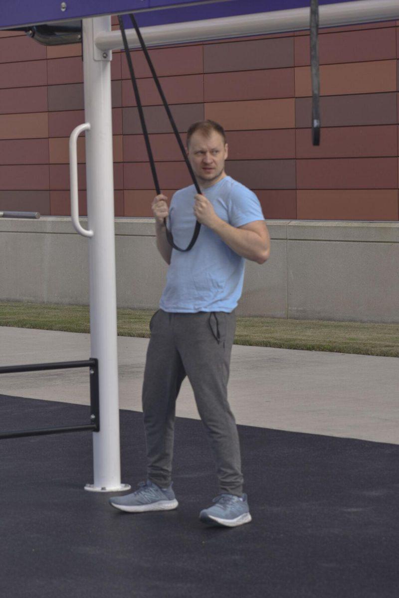 An LSU student pulls on a resistance band Wednesday, Jan. 26, 2022, at the UREC Outdoor Space.