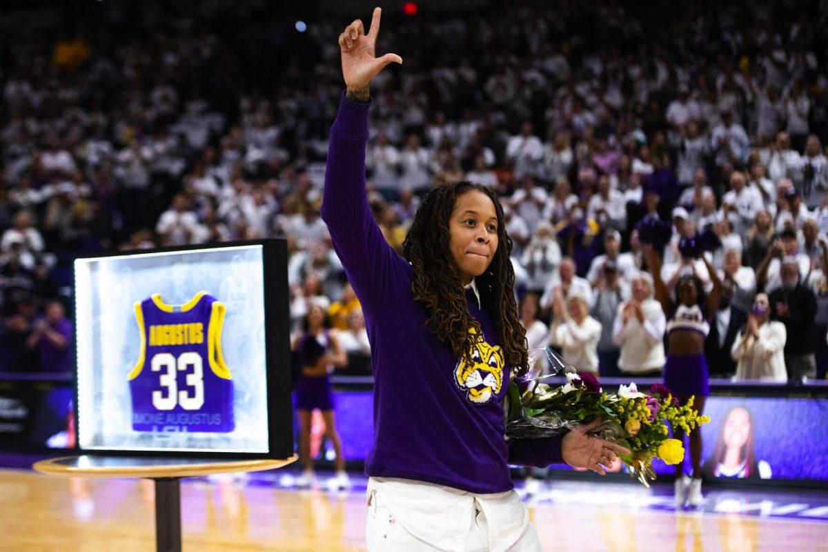 LSU women’s basketball alum Seimone Augustus raises up a “L” for LSU during her honor ceremony Thursday, Jan. 06, 2022, before LSU’s 66-60 loss against South Carolina in the Pete Maravich Assembly Center on North Stadium Drive in Baton Rouge, La.