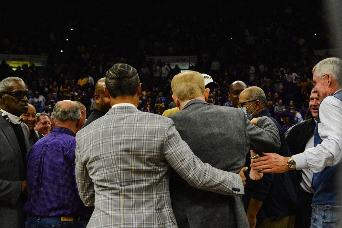 Longtime LSU basketball coach Dale Brown embraces with his former players Tuesday, Jan. 04, 2022, during LSU&#8217;s 56-50 win against Kentucky in the Pete Maravich Assembly Center on North Stadium Drive in Baton Rouge, La.