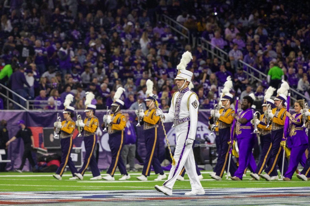 LSU Drum Major Nicholas Robichaux leads the LSU Tiger Band onto the field Tuesday, Jan. 4, 2022, during LSU&#8217;s 42-20 loss against Kansas State at NRG Stadium in Houston, TX.