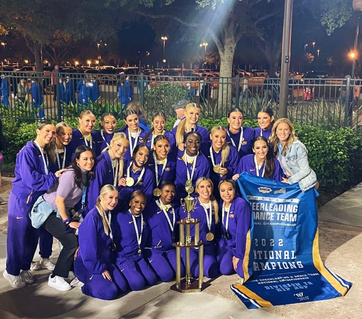 The LSU Tiger Girls pose around the National Championship trophy.