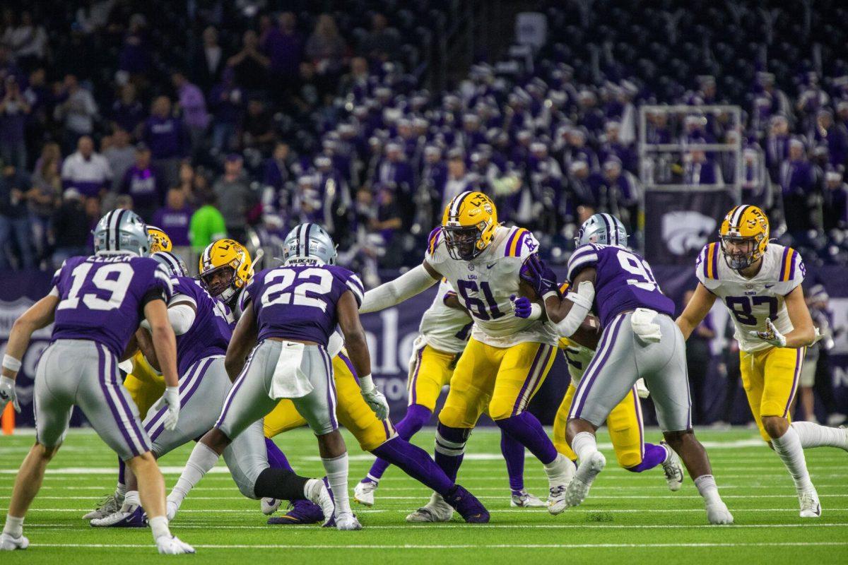 LSU football junior offensive tackle Cameron Wire (61) paves the way for the running back Tuesday, Jan. 4, 2022, during LSU&#8217;s 42-20 loss against Kansas State at NRG Stadium in Houston, TX.