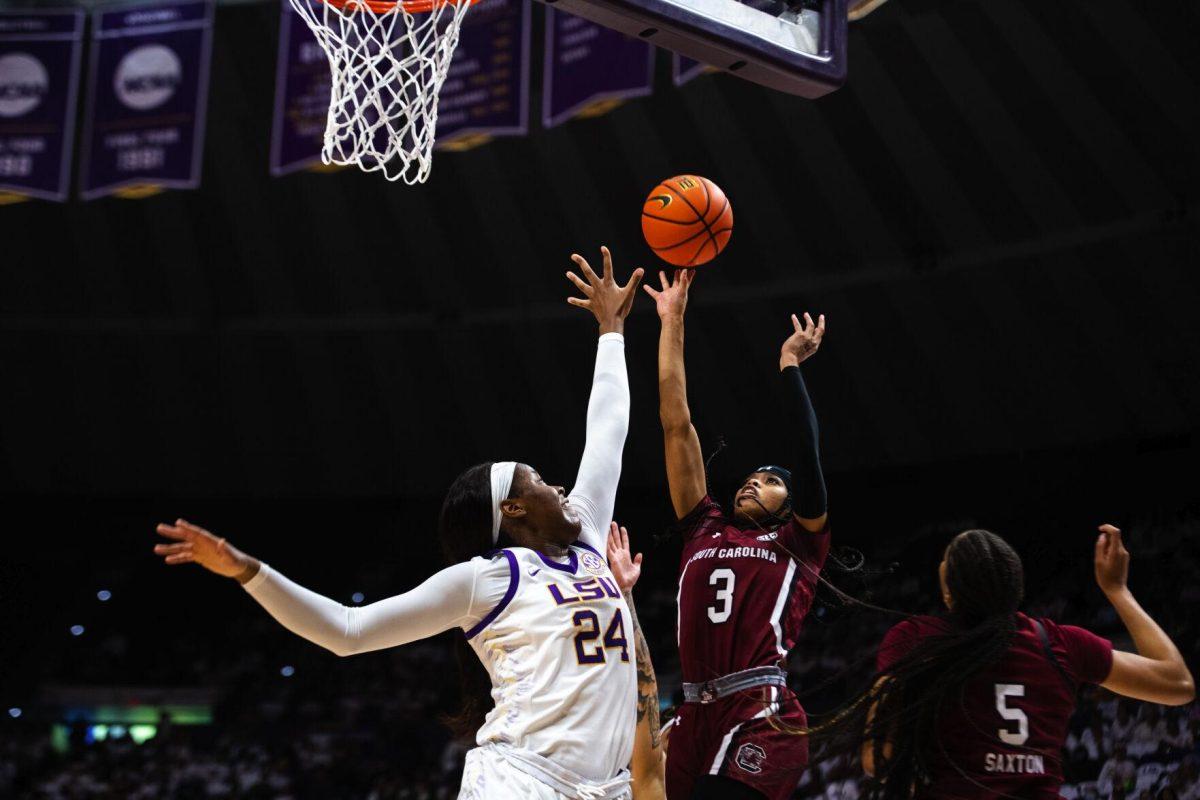 LSU women’s basketball graduate student center Faustine Aifuwa (24) attempts to block South Carolina women’s basketball senior guard Destanni Henderson (3) Thursday, Jan. 06, 2022, during LSU’s 66-60 loss against South Carolina in the Pete Maravich Assembly Center on North Stadium Drive in Baton Rouge, La.