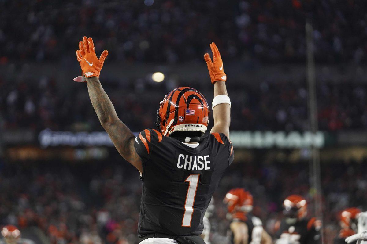 Cincinnati Bengals' Ja'Marr Chase signals for a touchdown on a ball caught by Tyler Boyd during the first half of an NFL wild-card playoff football game against the Las Vegas Raider, Saturday, Jan. 15, 2022, in Cincinnati. (AP Photo/Jeff Dean)