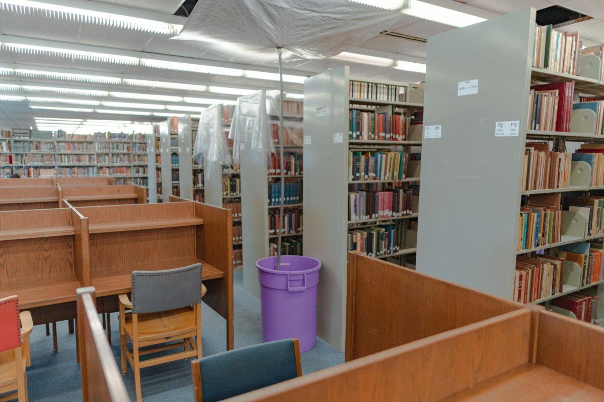 A tube leads into a garbage can on Tuesday, Jan. 18, 2022, to collect any water leaking from the roof of the LSU Library in Baton Rouge, La.