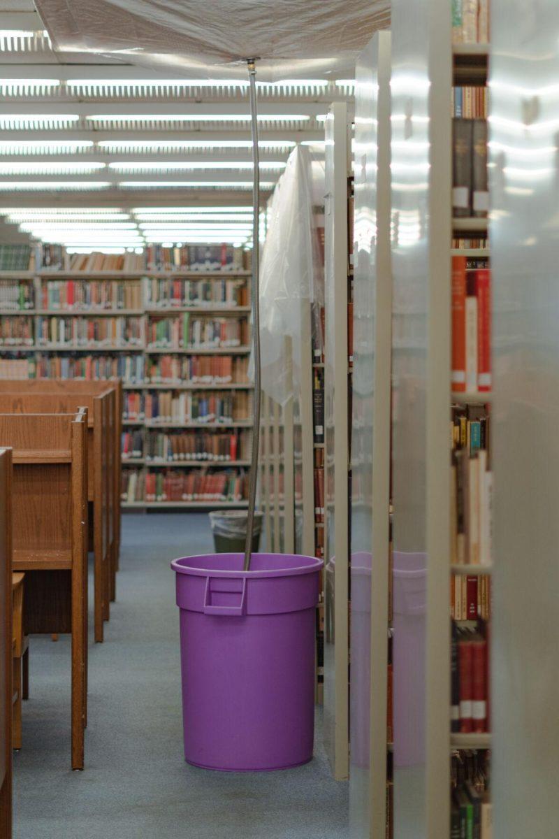 A tube leads into a garbage can on Tuesday, Jan. 18, 2022, to collect any water leaking from the roof of the LSU Library in Baton Rouge, La.