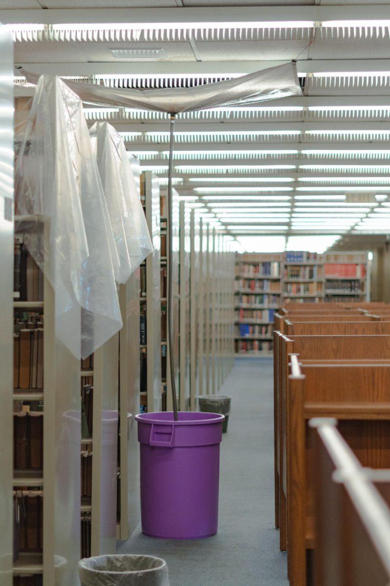 A tube leads into a garbage can on Tuesday, Jan. 18, 2022, to collect any water leaking from the roof of the LSU Library in Baton Rouge, La.