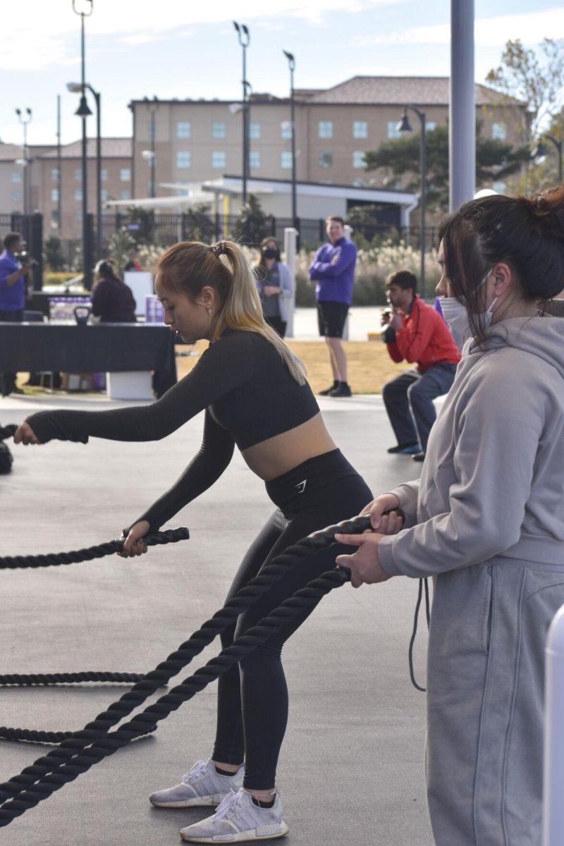 Two LSU students wave battle ropes Wednesday, Jan. 26, 2022, at the UREC Outdoor Fitness Space.