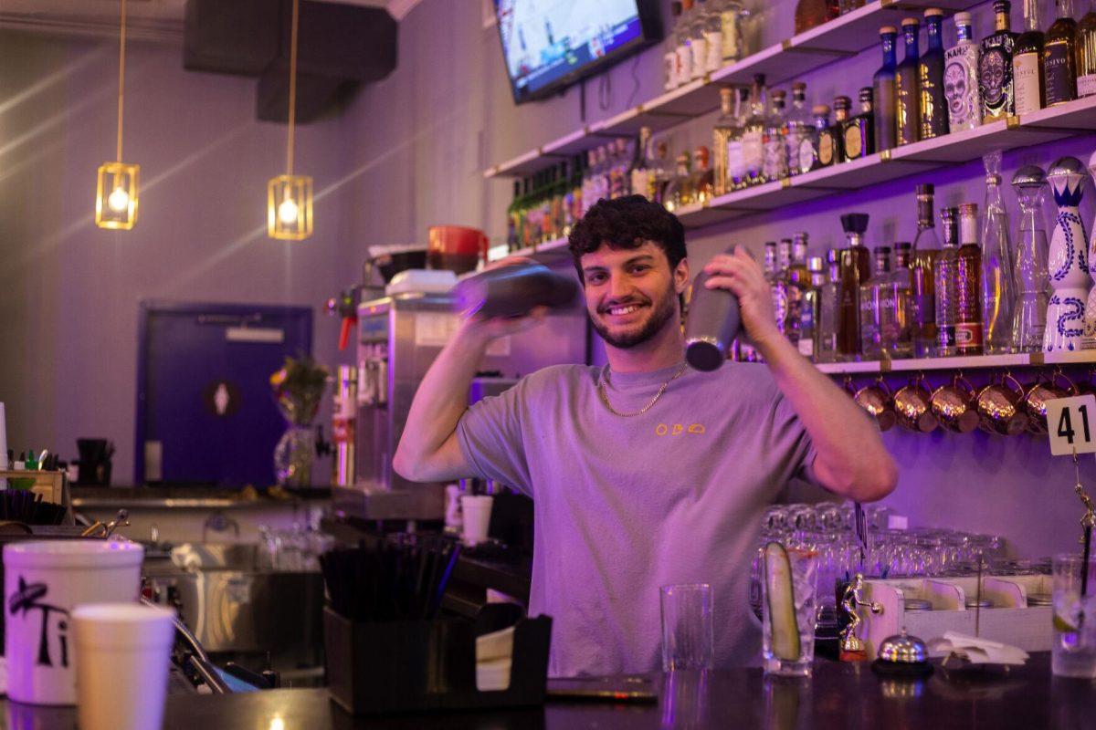 LSU alumni environmental management systems major, class of 2021, Patrick Winkeljohn prepares drinks at the bar Tuesday, Jan. 18, 2022, at Rock Paper Taco on 166 W Chimes St. in Baton Rouge, La.