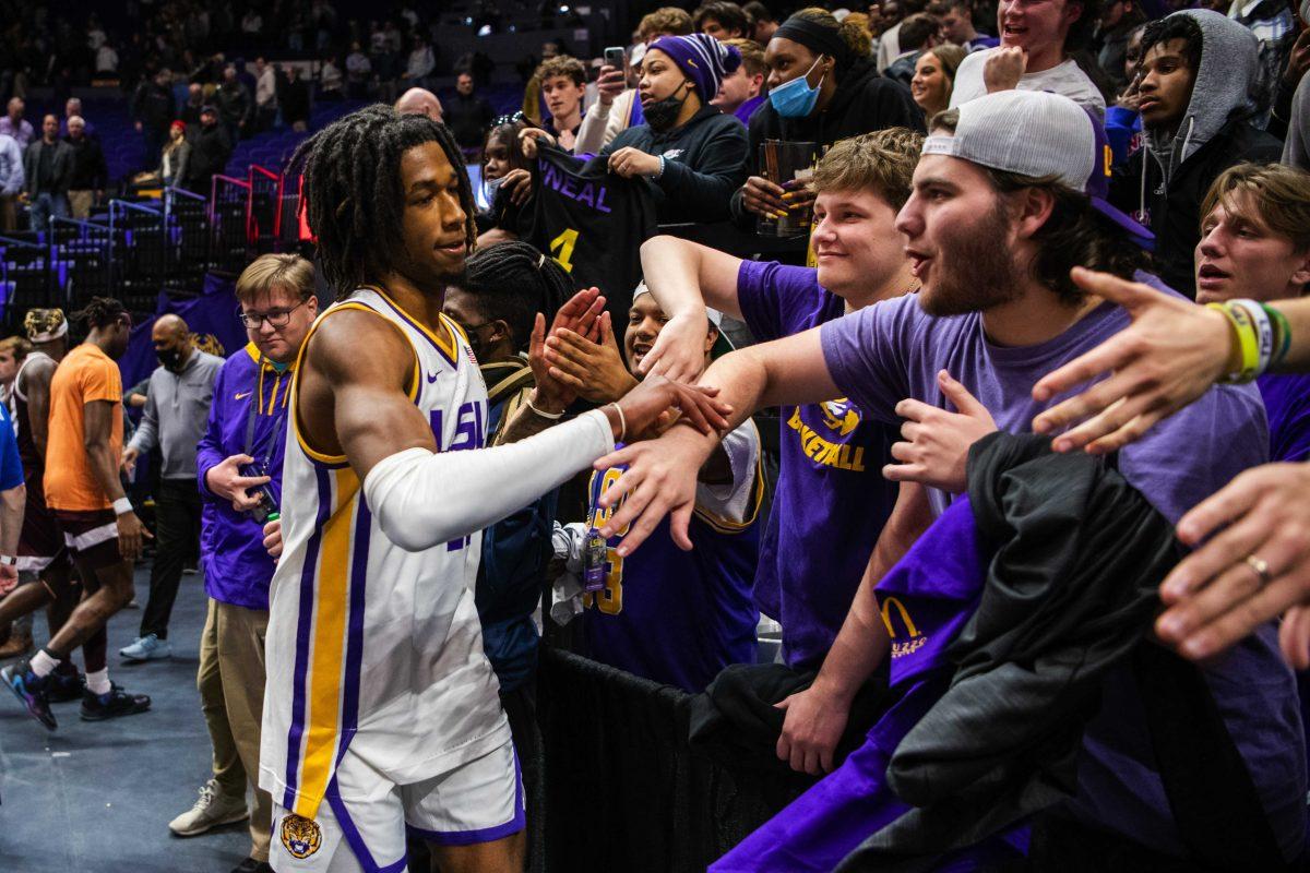 LSU men&#8217;s basketball freshman guard Justice Williams (11) high-fives fans Wednesday, Jan. 26, 2022, after LSU&#8217;s 70-64 win against Texas A&amp;M in the Pete Maravich Assembly Center on North Stadium Drive in Baton Rouge, La.