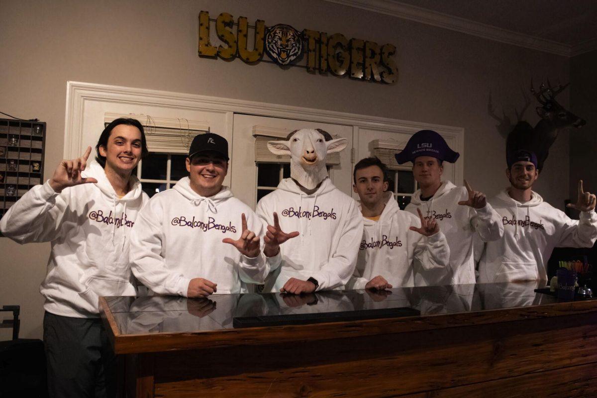 Brandon Barrient, Gant Gautreaux, Goat Man, Dean Compton, Eli Coleman and Myes Diez smile behind their bar setup. 